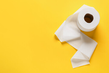 Roll of toilet paper on color background