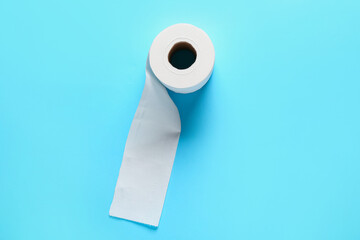 Roll of toilet paper on color background