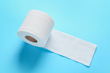 Roll of toilet paper on color background