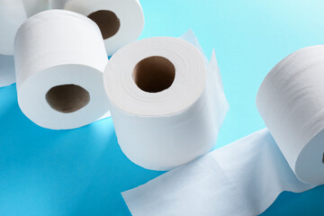 Rolls of toilet paper on color background