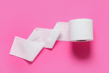 Roll of toilet paper on color background