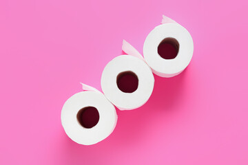 Rolls of toilet paper on color background