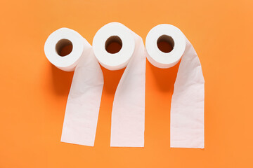 Rolls of toilet paper on color background