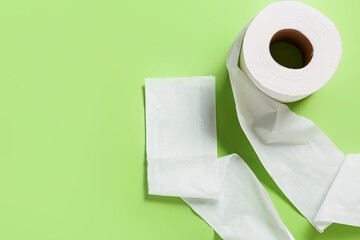 Roll of toilet paper on color background