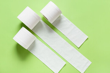Rolls of toilet paper on color background