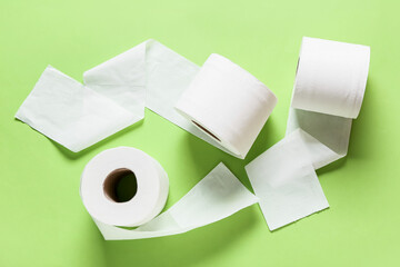 Rolls of toilet paper on color background