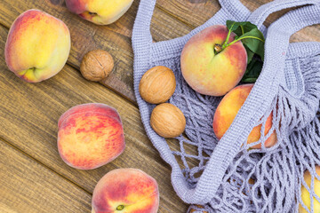 Peaches and walnuts in gray fabric net