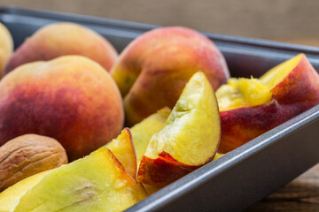 Ripe peaches in metal tray. Close up