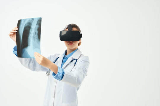 female doctor in white coat x-ray virtual reality glasses technology hospital