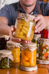 Young man holding in hands preserved food