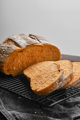 Closeup view of artisan whole grain tomato wheat bread cut on slices on kitchen table