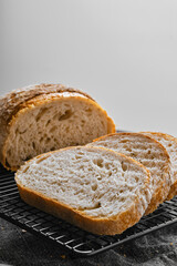 Closeup view of artisan whole grain wheat bread cut on slices on kitchen table