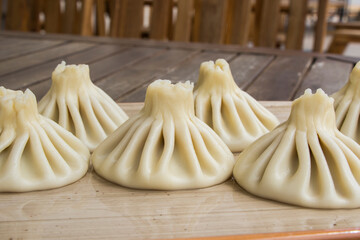 Georgian traditional food khinkali on the plate in restaurant, ready to eat, hot dish.