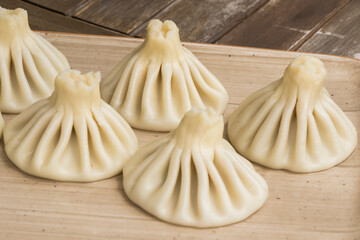 Georgian traditional food khinkali on the plate in restaurant, ready to eat, hot dish.