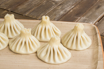 Georgian traditional food khinkali on the plate in restaurant, ready to eat, hot dish.