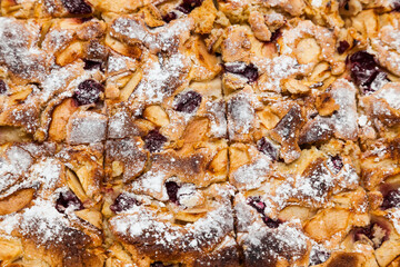 Baked pie with apples and cherries, cut into pieces. Baked pie 