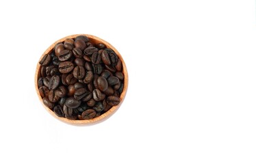 Coffee beans in a wooden bowl isolated on a white background, top view