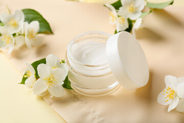 Fototapeta na wymiar Jar of cream and jasmine flowers on color background