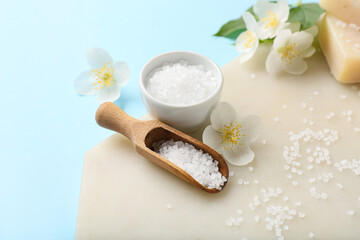 Composition sea salt and jasmine flowers on color background