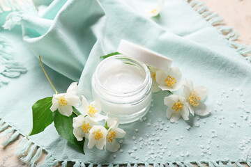Obraz na płótnie Canvas Composition with jar of cream and jasmine flowers on table