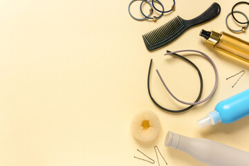 Flat lay of accessories and hair care products on beige background. Space for text