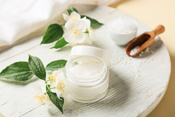 Fototapeta na wymiar Composition with jar of cream, sea salt and jasmine flowers on color background, closeup