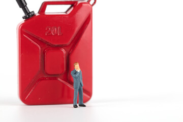 Fototapeta premium Businessman next to petrol barrel on white background