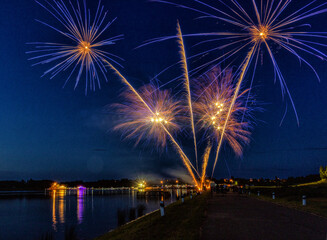 Summer fireworks in the dark blue sky