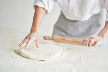 woman chef rolls out dough bakery cooking pastry