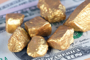 Scattered gold on dollar bills