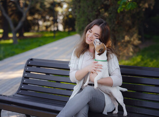 Young woman with her cute Jack Russell Terrier outdoor.