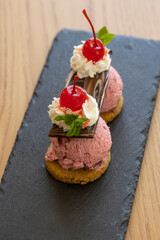 Ice cream dessert served on a black stone in the restaurant