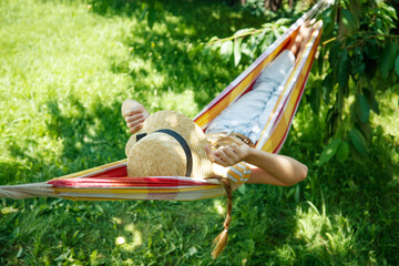 Summer vacation - lovely girl in a colorful hammock. High quality photo - 445107968