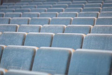 Fototapeta premium A row of empty blue chairs in the auditorium.
