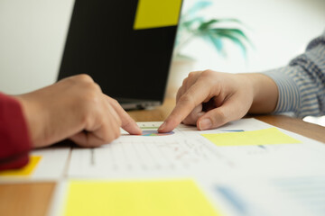 Two business leaders talk about charts, financial graphs showing results are analyzing and calculating planning strategies, business success building processes