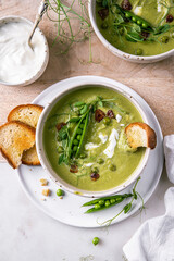 Cream of green peas soup with toasts and sour cream.