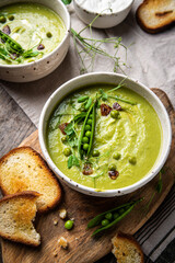 Cream of green peas soup with toasts and sour cream.