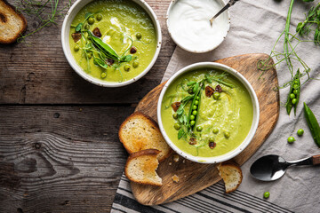 Cream of green peas soup with toasts and sour cream.