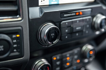 Car radio front volume closeup. Car radio controls. Modern car audio system. Interior Of Luxury Car.