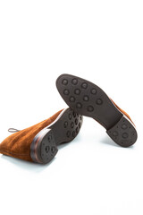Closeup of Pair of Male Brown Suede Chukka Boots Placed One on One Together On White Background.