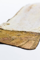 Extreme Texture Closeup of Brown Used Removable Shoe Insole Placed Over White Background with Shallow Depth of Field