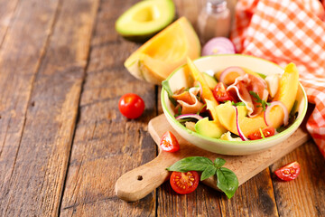 melon slices with avocado, mozzarella and ham