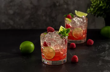 Foto op Plexiglas Bourbon or rum raspberry smash cocktail with lime and mint. Refreshing cold drink. © Jane Vershinin