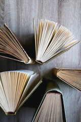 Vintage hardcover books on a wooden table. Top view.