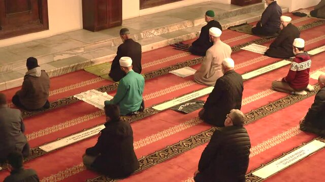 Muslim eid congregation praying.Mosque teacher imam is reading the Quran.Reads Qur'an interior god religion mysterious religious islam moslem place of worship prayer temple azan salaah spirituality 4K
