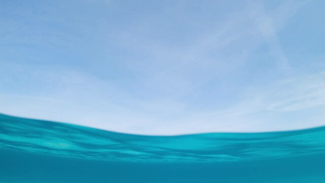 Split-shot, over-under shot. Stunning view of half underwater half sky with a beautiful and turquoise water. Liscia Ruja, Sardinia, Italy.