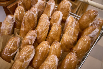 Lots fresh crisp loaves of bread. Variety of baked products at a supermarket. Shop window in a bakery
