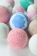 Different bath balls on white background, close up