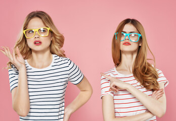 two pretty women in sunglasses striped t-shirts summer friends chatting - obrazy, fototapety, plakaty
