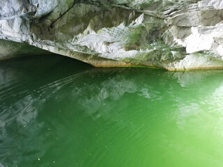 The wall of the grotto, reflected in the emerald water of the Marble Canyon in the Ruskeala...